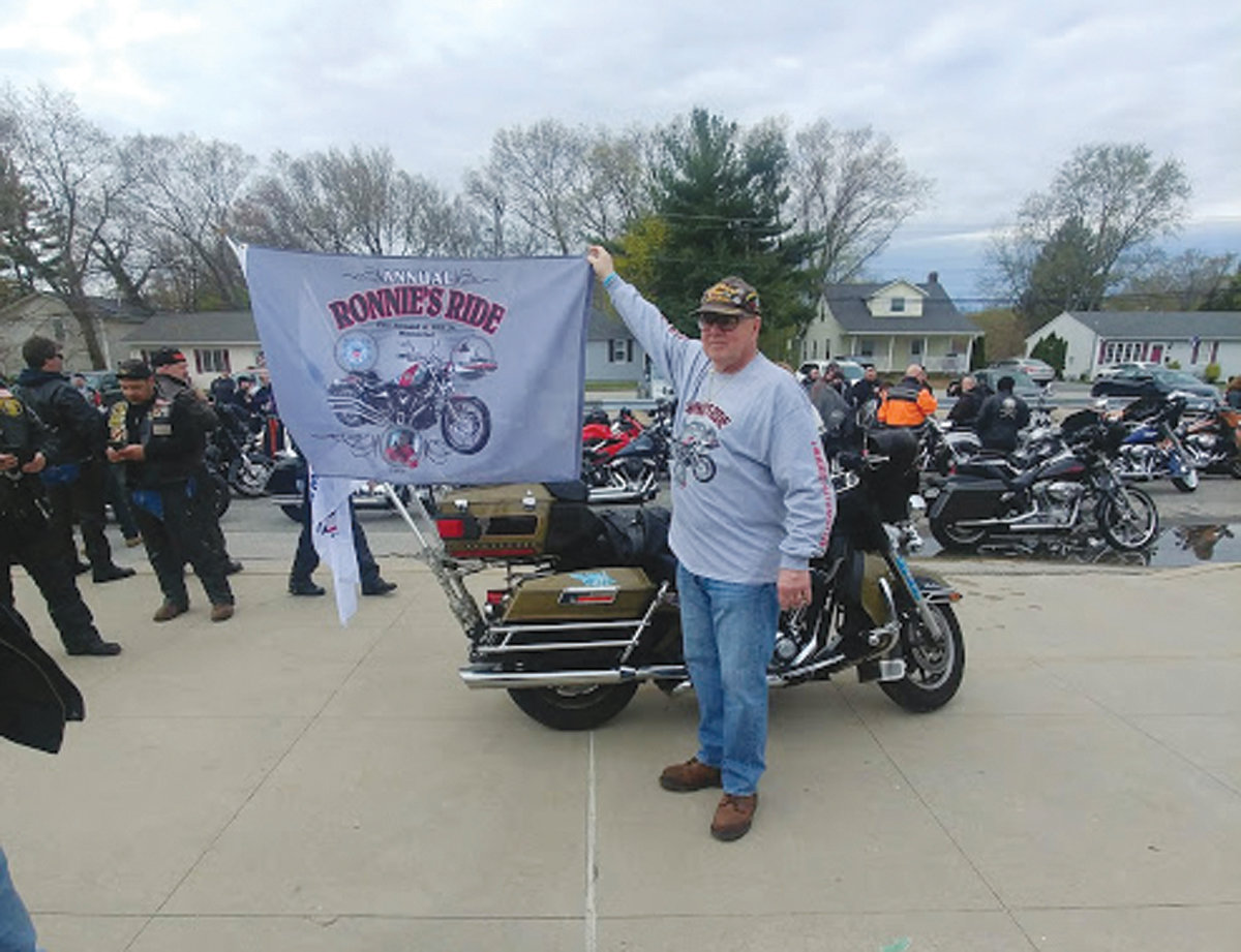 ANOTHER YEAR, NEVER EASIER: Ron Gill Sr. shows this year’s event flag, the 11th since his son’s tragic death in a Coast Guard accident. Each year, he expresses that despite the amount of time that has passed since that day, it does not ever get any easier.